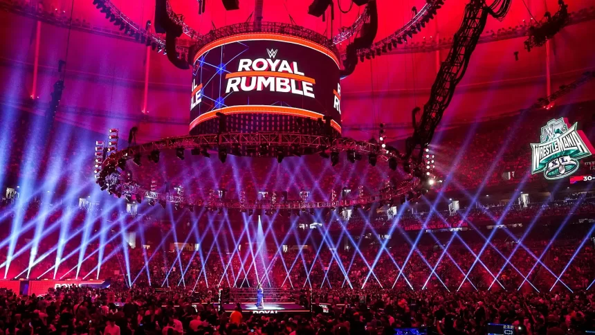 Arena lotada com palco iluminado e telão do Royal Rumble antes do início do evento — imagem ilustrando todos os vencedores do Royal Rumble.